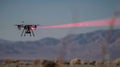A demonstration of a laserbased counterdrone system precisely targeting and disabling a small drone from a safe distance Royalty Free Stock Photo