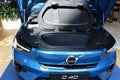 Demonstration of opened front trunk of modern electric luxury crossover electric car Volvo C40, light blue color