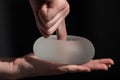 Silicone implant of the female breast during the demonstration of its quality.