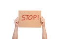 Demonstrator hands are holding protest poster with the message Stop. Royalty Free Stock Photo