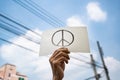 Demonstrator holding paper with peace symbol