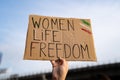 Demonstrator holding `Women, Life, Freedom` placard Royalty Free Stock Photo