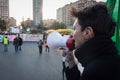 Demonstrator with loudhailer protesting against the government in Milan, Italy