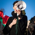 Demonstrator with loudhailer protesting against the government in Milan, Italy