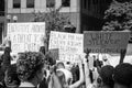 Demonstrators Hold Up Signs at a Protest of the Murder of George Floyd Royalty Free Stock Photo