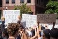 Demonstrators Hold Up Signs at a Protest of the Murder of George Floyd