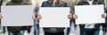 Demonstrators Holding Blank Signs at Public Protest Image of three individuals holding blank signs in an open public space Royalty Free Stock Photo