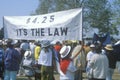 Demonstrators holding up banner for labor laws