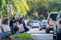 Demonstrators kneeling and raising fists with passing motorists for Black Lives Matter movement