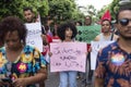 Demonstrators walk with posters, banners and flags during the Crespo Empowerment March in Salvador, Bahia