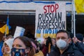 Demonstrators with yellow and blue Ukraine flags and anti-war signs near Russian consulate