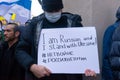 Demonstrators with yellow and blue Ukraine flags and anti-war signs near Russian consulate