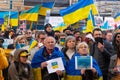 Demonstrators with yellow and blue Ukraine flags and anti-war signs near Russian consulate