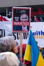 Demonstrators with yellow and blue Ukraine flags and anti-war signs near Russian consulate