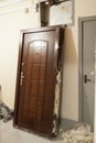 Demounted old steel door is in hall. Home renovation, nobody