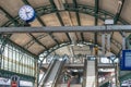 Railway station concourse with escalators, information panel and clock Royalty Free Stock Photo