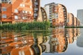 Dutch sail buildings reflecting in pond