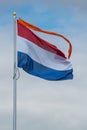 Den Helder, Netherlands. May 31, 2023. Flying dutch flag with orange banner.