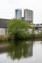 Dendermonde, East Flanders, Belgium - Industrial buildings reflecting in the river Dender