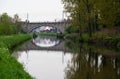 Dendermonde, East Flanders, Belgium - Old bowed bridge reflecting in the water of the River Dender