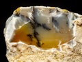 Dendritic opal. Opal on a black background. Opal is a hydrated amorphous form of silica. the mineral sample