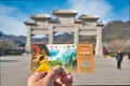 Dengfeng,Henan,China - December 29, 2019: Asian holding entrance ticket at Shaolin Temple white front gate the famous place in