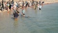 DENHAM, AUSTRALIA - MAY, 25, 2021: front view of two children feeding a dolphin at monkey mia