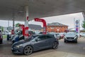 DENHAM, ENGLAND - 25 September 2021: Queue of cars waiting to fill up on fuel outside Esso petrol station amid fuel shortage