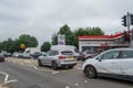 DENHAM, ENGLAND - 25 September 2021: Queue of cars waiting to fill up on fuel outside Esso petrol station amid fuel shortage