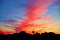 Denia sunset sky with palm trees and mountains