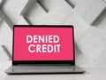 Denied Credit is shown on the photo using the text