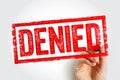 DENIED stamp held by a hand, forming a bold textured refusal mark ideal for declined requests, failed applications, and Royalty Free Stock Photo
