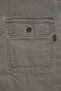 Denim background made of khaki denim textiles. On the pocket is sewn a tag for applying text or logo. Royalty Free Stock Photo