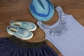 Denim blue shoes, belt, T-shirt and hat on the brown floor Royalty Free Stock Photo