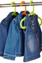 Denim child clothes hang in a closet