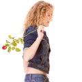 Denim fashion. Side view blonde girl in blue jeans with red rose Royalty Free Stock Photo