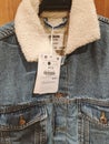 Denim jacket with faux fur with price tag on a hanger