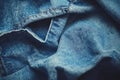 Denim jeans fabric close-up highlighting texture, stitching and folds, creating an abstract pattern Royalty Free Stock Photo