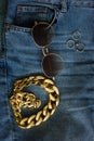 Gold chain, glasses and rings on jeans. Top view. Flat layout Royalty Free Stock Photo