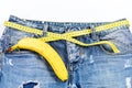 Denim pants with banana imitating male genitals on white background Royalty Free Stock Photo