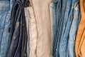 Denim pants folded in a pile on the counter, trade of men`s trousers