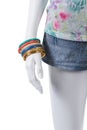 Denim shorts and colorful bracelets. Royalty Free Stock Photo