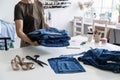 Denim Upcycling Ideas, Using Old Jeans, Repurposing Jeans, Reusing Old Jeans, Upcycle Stuff. Woman seamstress holding