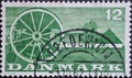 DENMARK - CIRCA 1960: A postage stamp from Denmark showing an seed drill in front of a farmhouse in Denmark Royalty Free Stock Photo