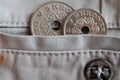 Denmark coins denomination is 5 and 2 krone (crown) in the pocket of beige denim jeans with button Royalty Free Stock Photo