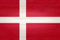 Denmark flag painted on old wood plank background. Brushed natural light knotted wooden board texture. Wooden texture background Royalty Free Stock Photo