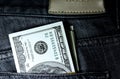 Denominations in denomination of one hundred dollars in a jeans pocket close-up