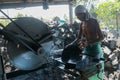 Denpasar, Bali, Indonesia, August 2020. Worker saws stone with circular saw for repairing. Power saw with disk