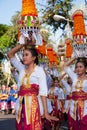 Procession of Balinese women in traditional sarongs carrying religious offering