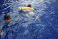 Swimming pool full of children learning to swim